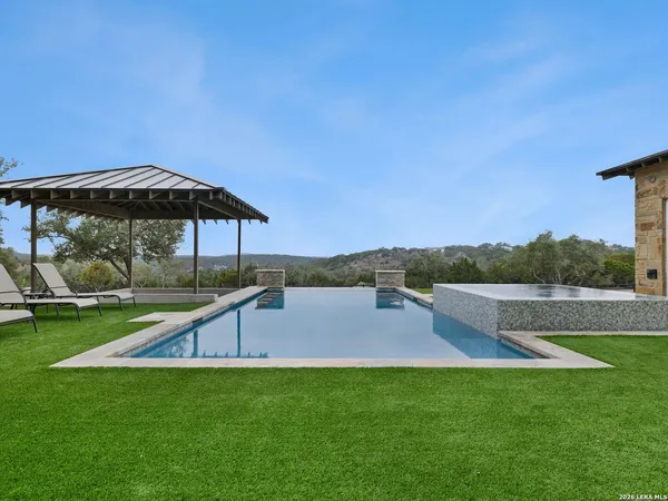 a view of a house with a yard and sitting area