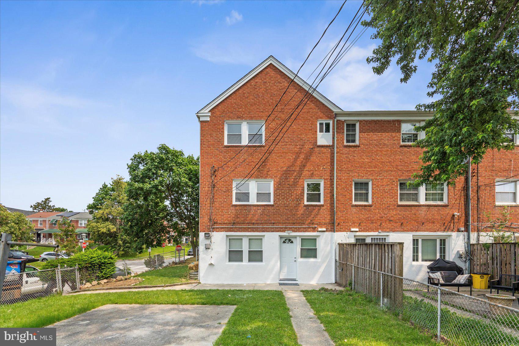 1601 Burnwood Road Baltimore, MD 21239 - Photo 13 of 46 a front view of a house with a yard