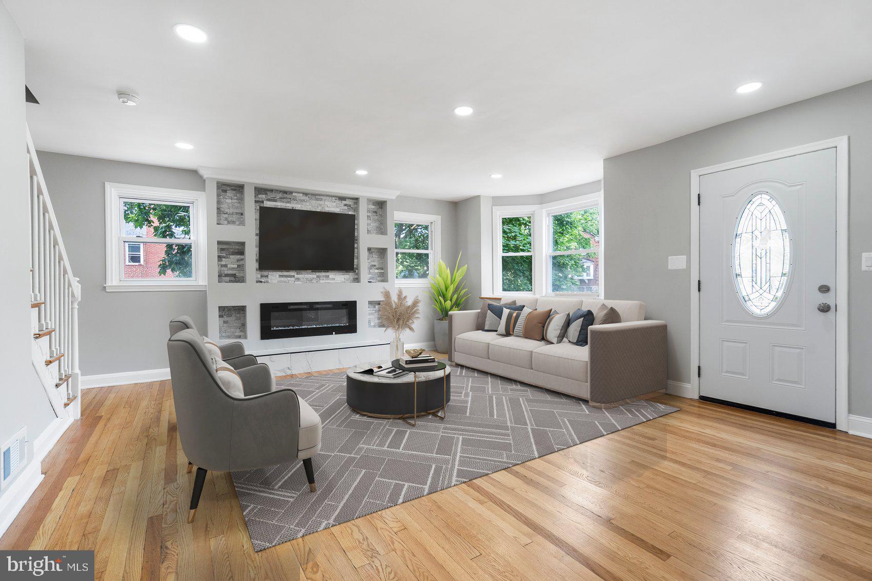 1601 Burnwood Road Baltimore, MD 21239 - Photo 2 of 46 a living room with furniture a fireplace and a flat screen tv