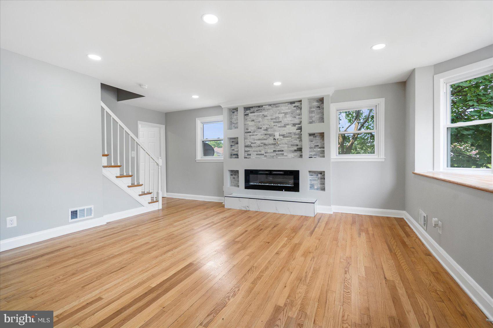 1601 Burnwood Road Baltimore, MD 21239 - Photo 23 of 46 a view of empty room with wooden floor and fireplace