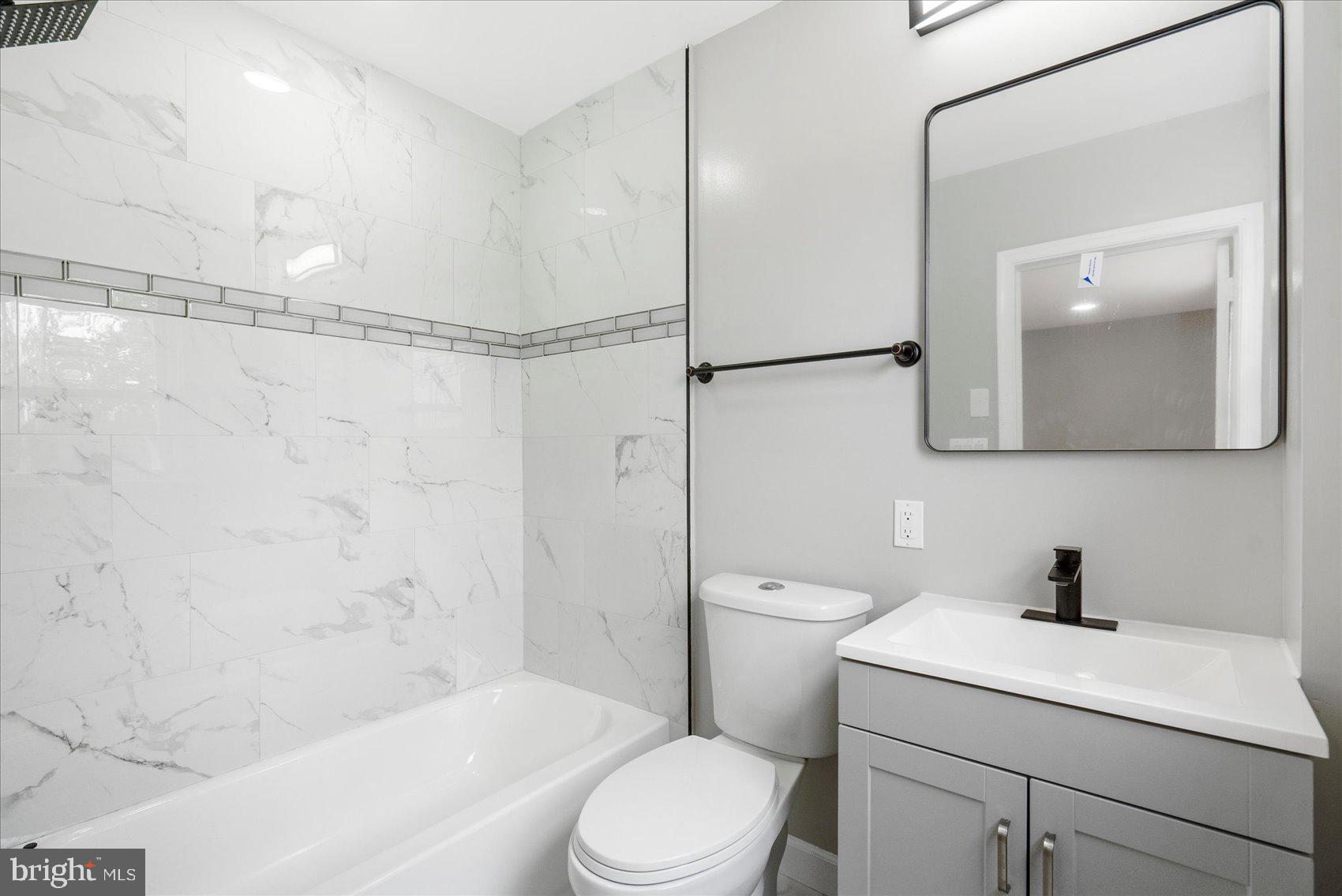 1601 Burnwood Road Baltimore, MD 21239 - Photo 31 of 46 a bathroom with a sink a toilet and shower