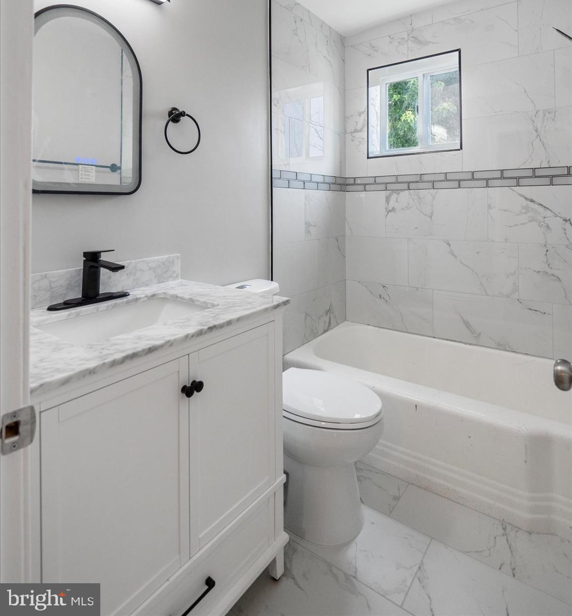 1601 Burnwood Road Baltimore, MD 21239 - Photo 39 of 46 a bathroom with a granite countertop sink mirror vanity and toilet