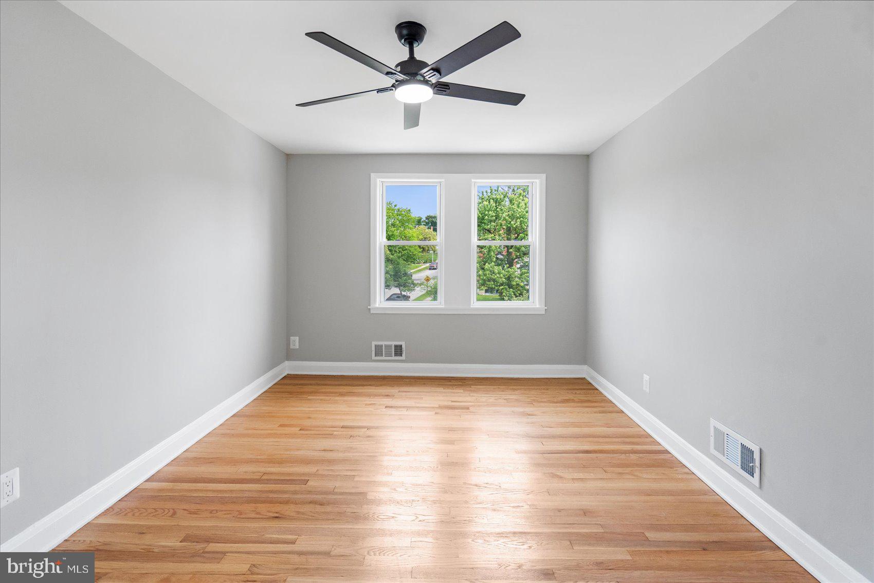 1601 Burnwood Road Baltimore, MD 21239 - Photo 40 of 46 a view of a room with wooden floor and a ceiling fan