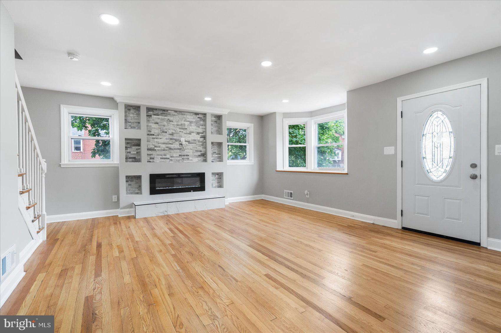 1601 Burnwood Road Baltimore, MD 21239 - Photo 6 of 46 an empty room with windows and fireplace