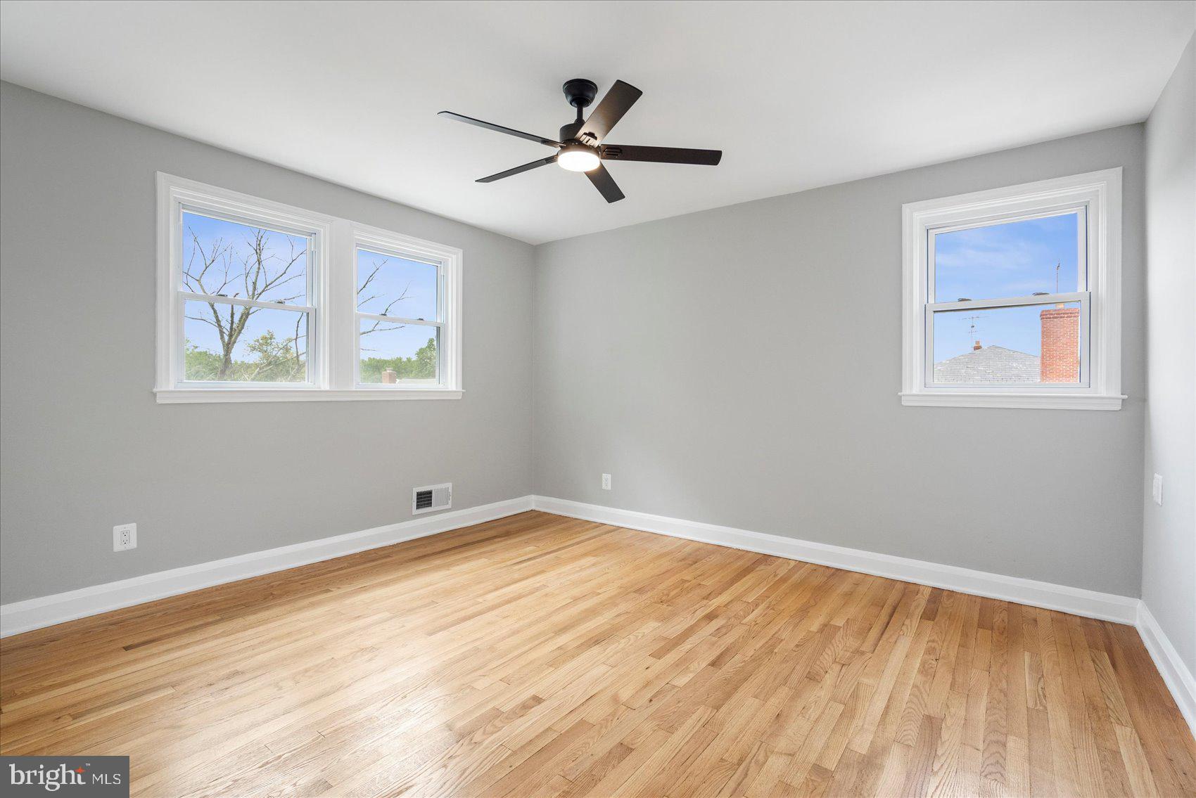 1601 Burnwood Road Baltimore, MD 21239 - Photo 7 of 46 a view of empty room with wooden floor and fan