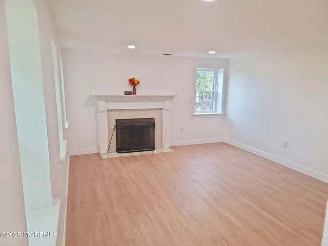 a view of empty room with a fireplace