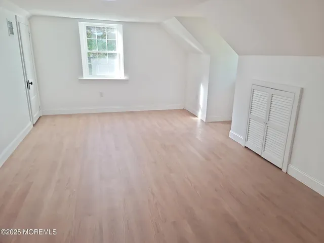 a hallway with sink with wooden cabinets