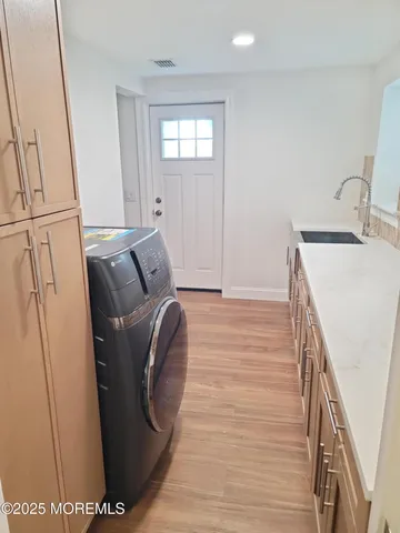 a kitchen with a sink and cabinets