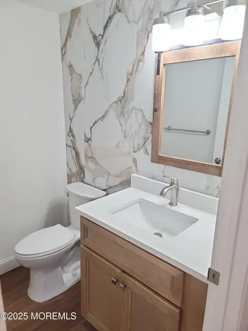 a bathroom with a sink toilet and mirror