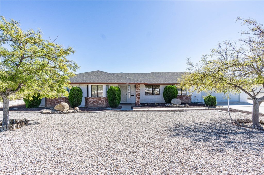 16391 Kamana Road Apple Valley, CA 92307 - Photo 1 of 1 a front view of a house with a yard and a garage