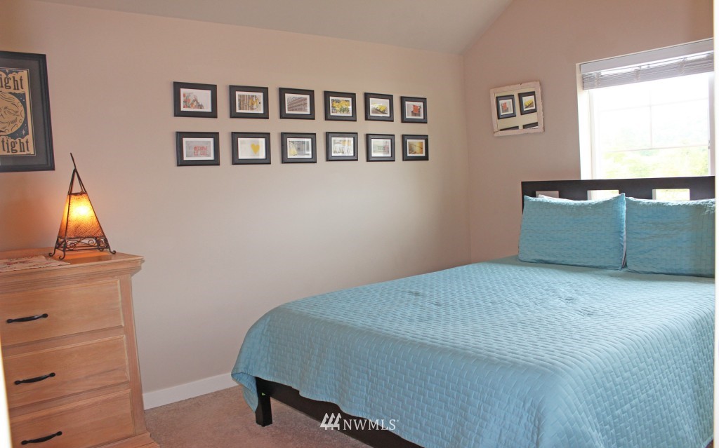 5020 Delridge Way Southwest, Unit A Seattle, WA 98106 - Photo 13 of 22 a bedroom with a bed and a window