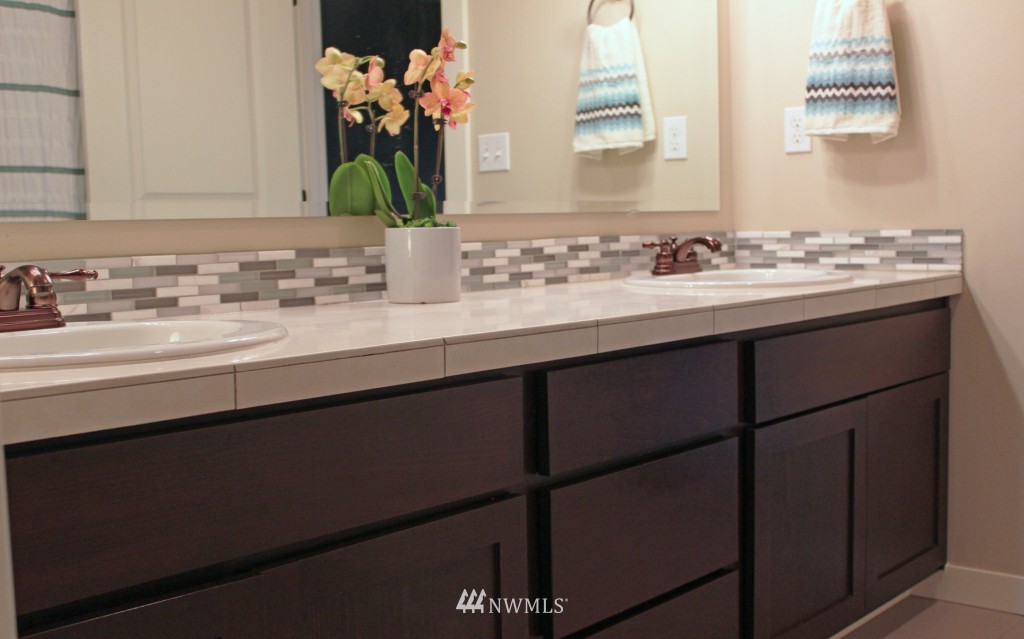 5020 Delridge Way Southwest, Unit A Seattle, WA 98106 - Photo 16 of 22 a bathroom with a sink and a mirror