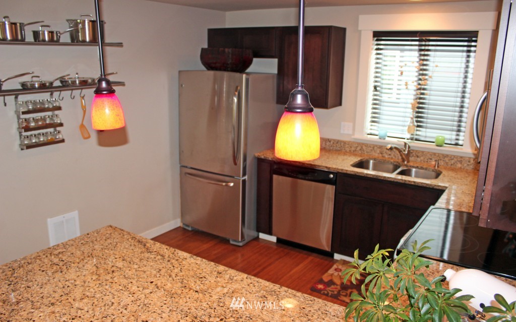 5020 Delridge Way Southwest, Unit A Seattle, WA 98106 - Photo 6 of 22 a kitchen with a sink and a refrigerator
