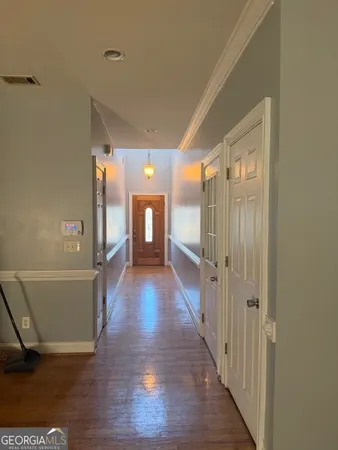 a view of a hallway with wooden floor
