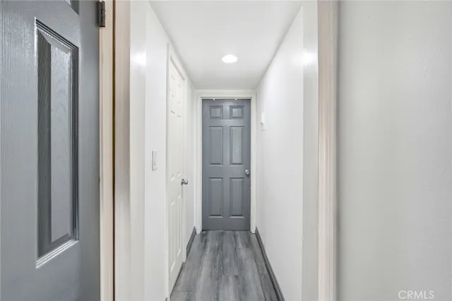 a view of a hallway with wooden floor