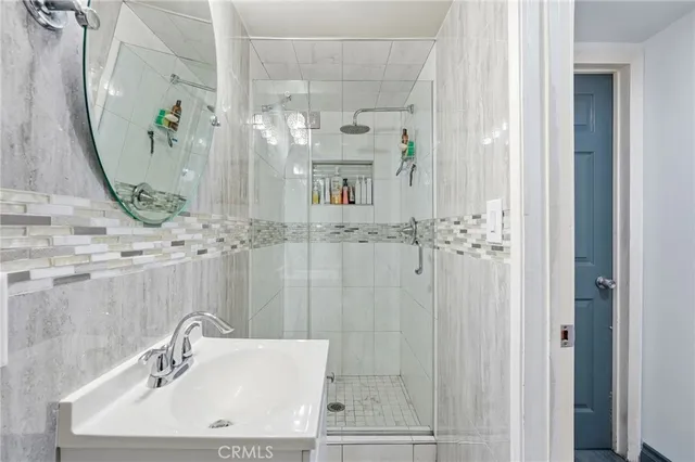 a bathroom with a sink a mirror and shower