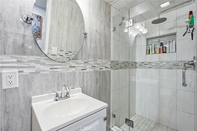 a bathroom with a sink a mirror and vanity