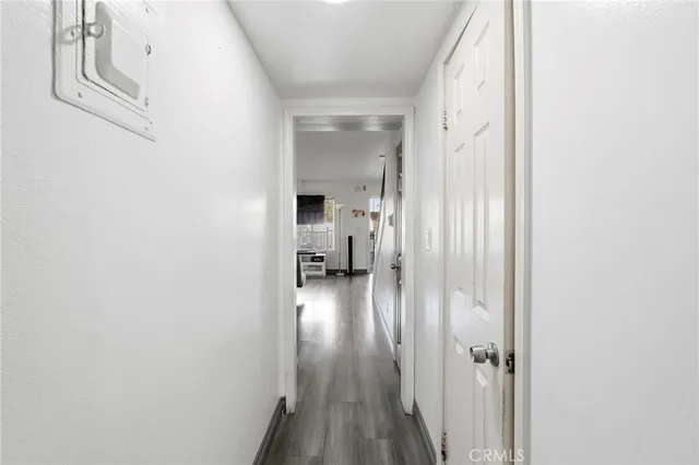 a view of a hallway with wooden floor