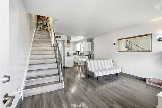 a view of entryway and hall with wooden floor