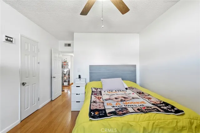 a bedroom with a bed and wooden floor