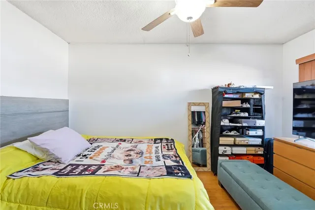 a bedroom with a bed and a wooden floor