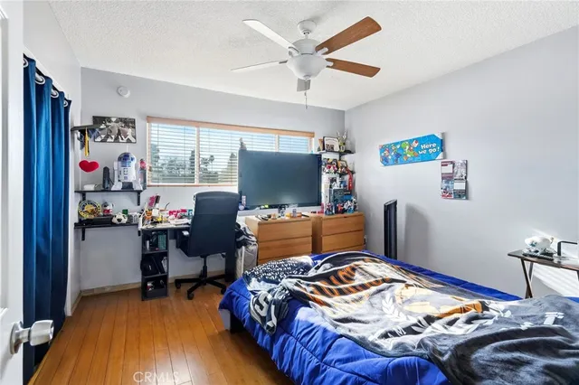 a bedroom with bed and a flat screen tv