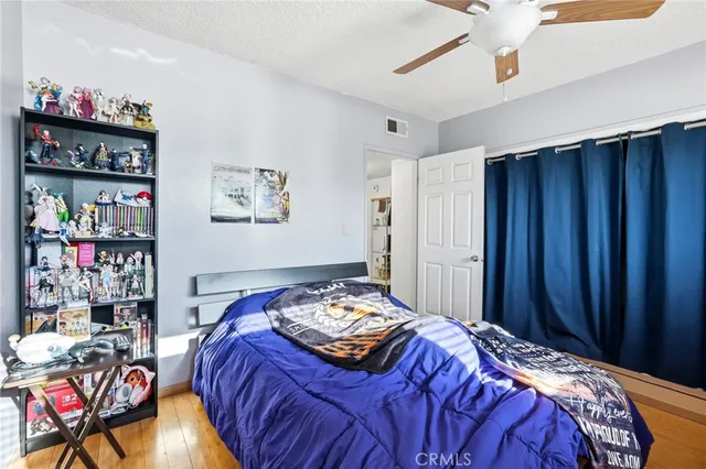 a bedroom with bed and book shelf