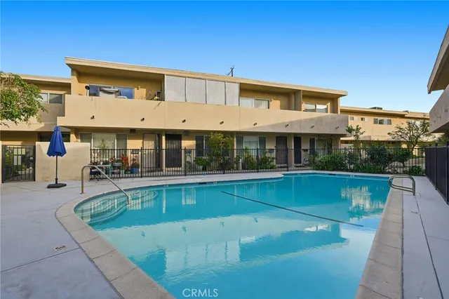a view of house with swimming pool and sitting area