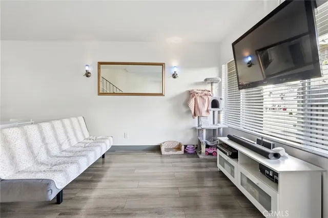 a living room with hard wood floors and a couch