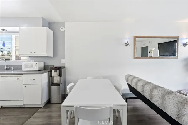 a kitchen with a table chairs sink and cabinets