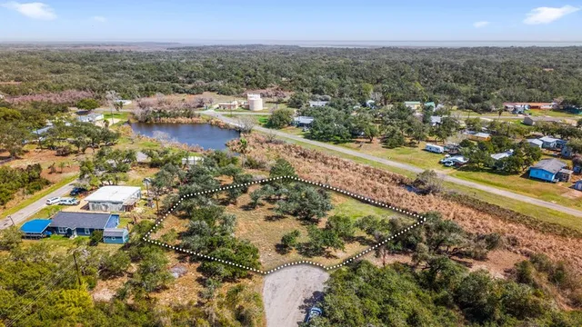 an aerial view of residential houses with outdoor space and river