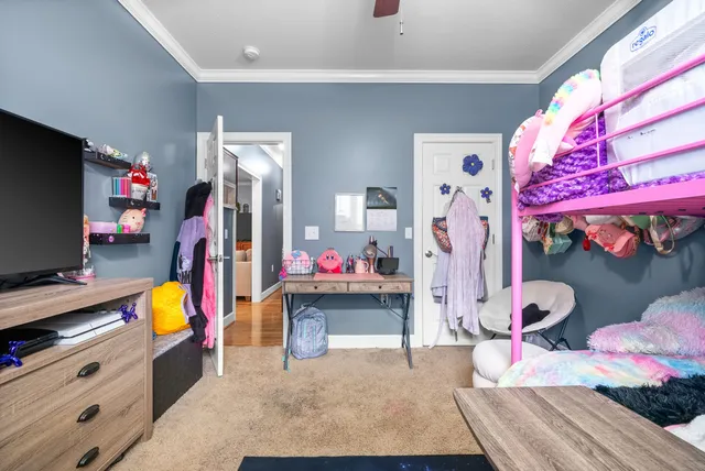 a bedroom with furniture and a flat screen tv
