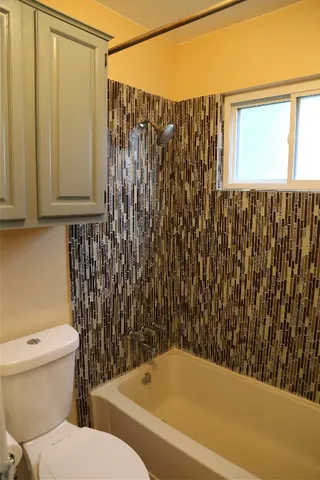a bathroom with a toilet and a shower curtain