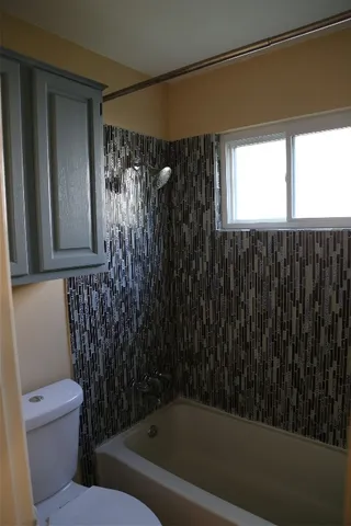 a bathroom with a toilet and shower