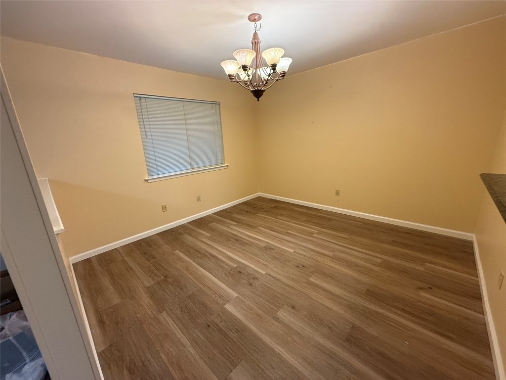 Undisclosed Address Austin, TX 78727 - Photo 25 of 36 a view of a room with wooden floor and chandelier