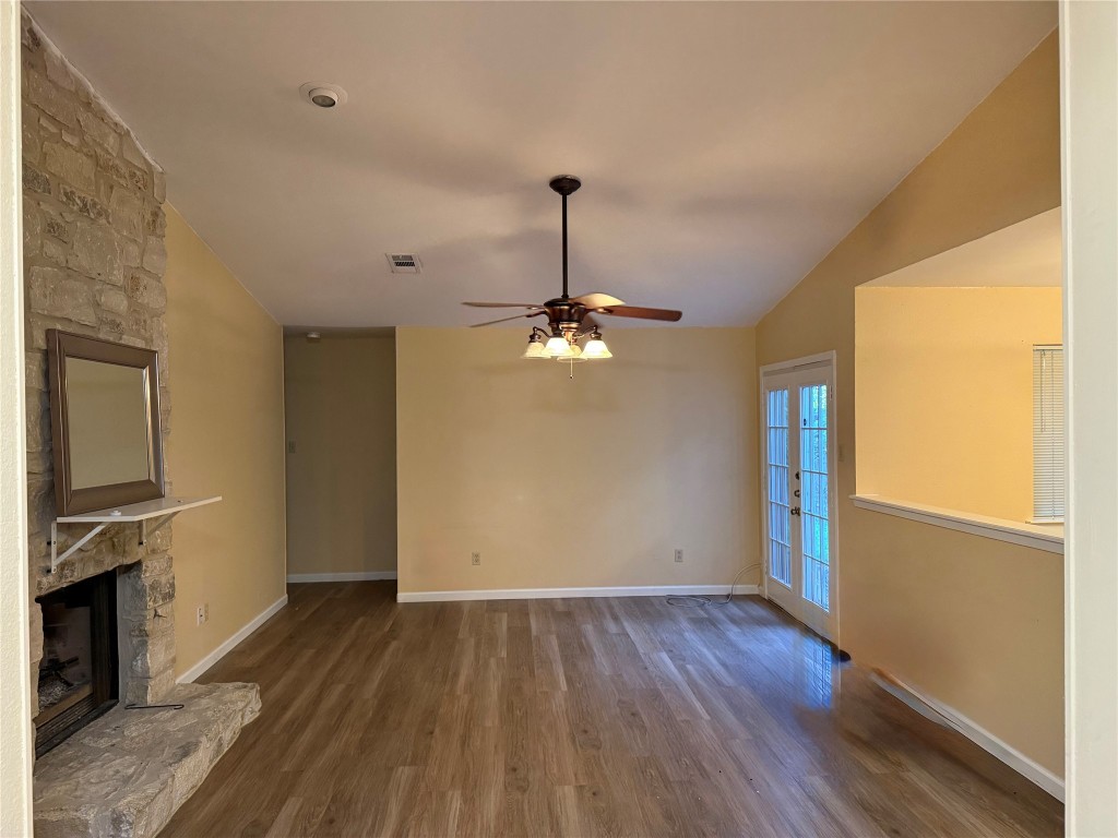 Undisclosed Address Austin, TX 78727 - Photo 27 of 36 a view of a livingroom with wooden floor a ceiling fan and windows