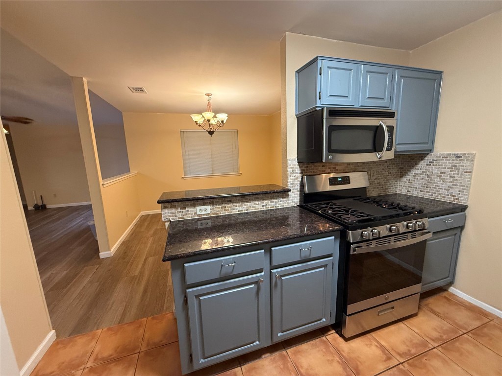 Undisclosed Address Austin, TX 78727 - Photo 29 of 36 a kitchen with granite countertop a stove microwave and sink