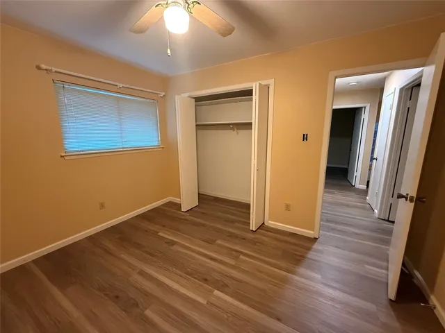 wooden floor in an empty room with a mirror
