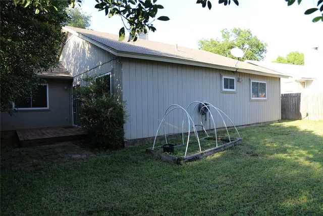 a backyard of a house with table and chairs