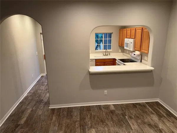 a view of hallway with a sink and a mirror