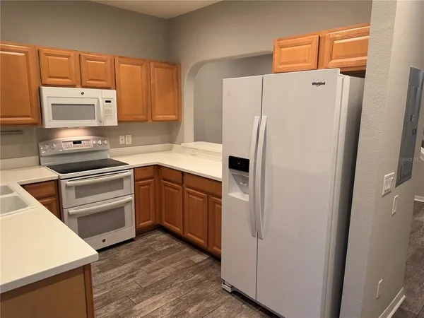 a kitchen with a refrigerator stove and microwave