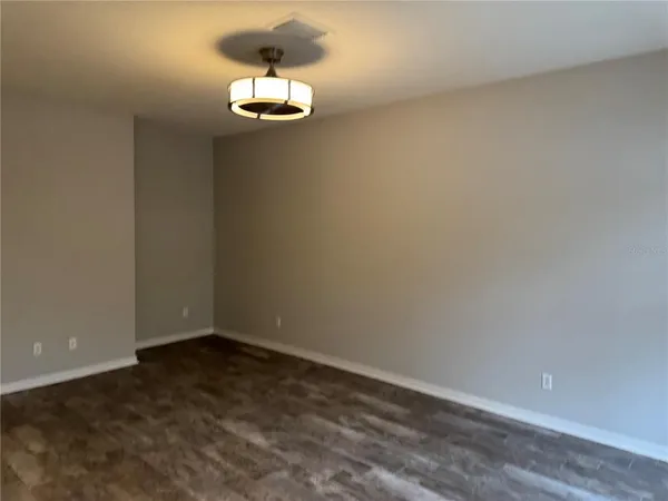 a view of a room with wooden floor and cabinet