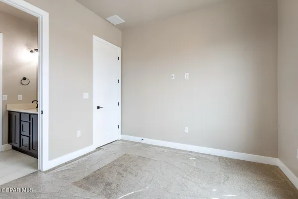 an empty room with closet and a bathroom