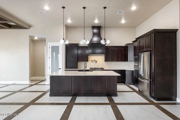 a kitchen with kitchen island a counter top space a sink appliances and cabinets