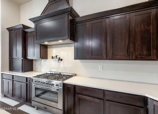 a kitchen with a table chairs and a ceiling fan