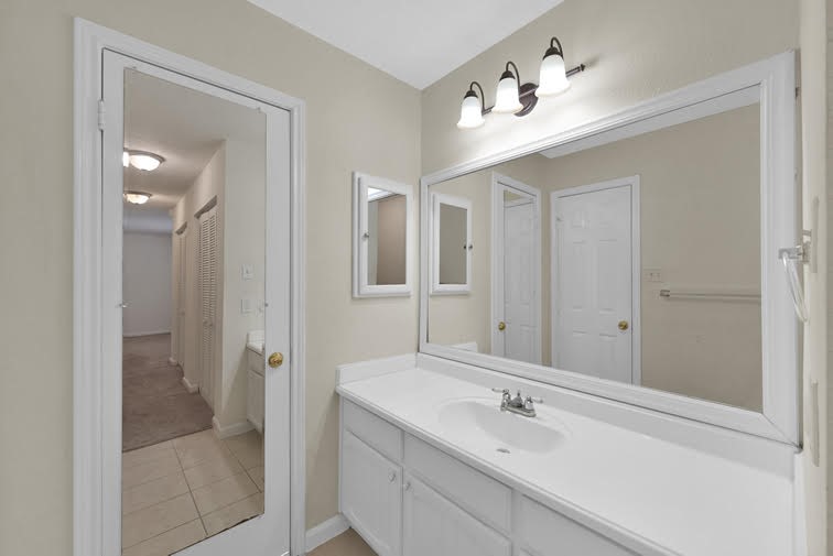 10902 Auger Place Spring, TX 77380 - Photo 16 of 21 a bathroom with a sink and a mirror