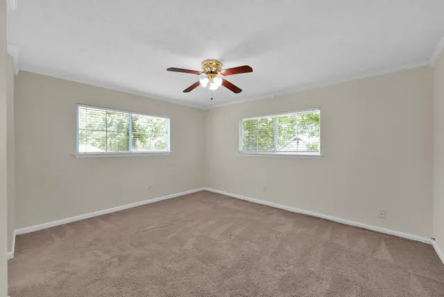 a view of room with a ceiling fan and window