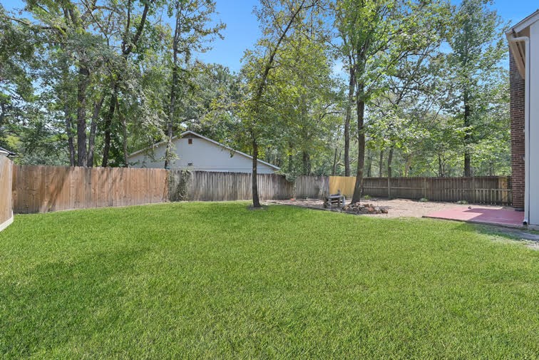 10902 Auger Place Spring, TX 77380 - Photo 19 of 21 a view of a backyard with a small cabin and a chair