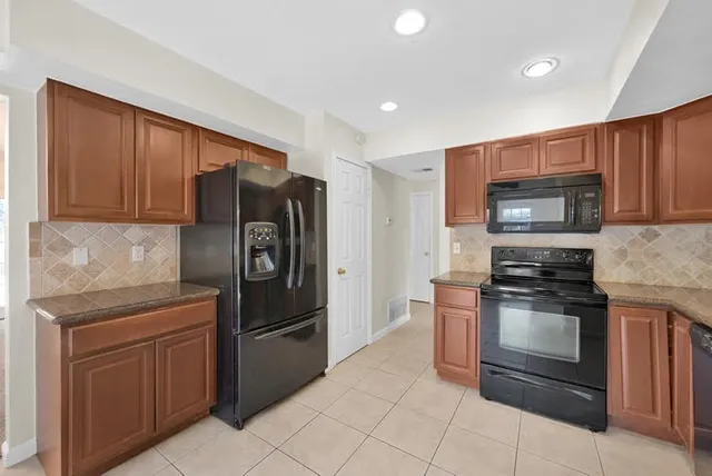 a kitchen with a refrigerator stove and microwave