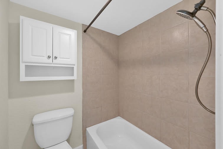 10902 Auger Place Spring, TX 77380 - Photo 10 of 21 a bathroom with a toilet a sink and mirror